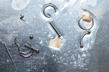 Piercing earrings close-up. On a black background.の写真素材