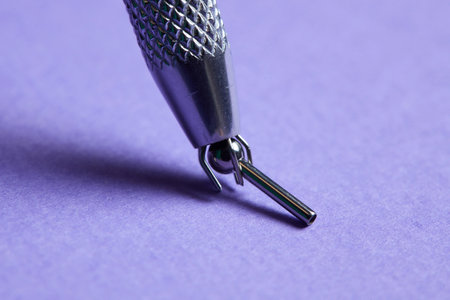 Piercing earrings close-up. On a Violet background.の写真素材