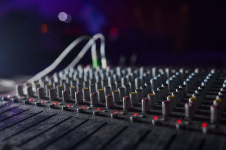 Sound mixer. Professional audio mixing console with lights, buttons, faders and sliders.