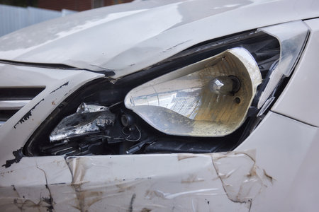 Damaged car broken headlights lens front bumper traffic accident.の写真素材