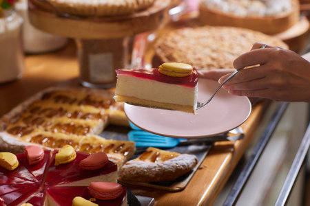 Table with sweets: cookies with strawberries, sponge cake, donuts, sweet rolls, cake. A sweet buffet at a party, an outdoor dinner, a wedding.の写真素材