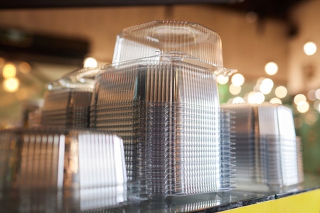 Plastic crates. Transparent white plastic containers are stacked together, plastic carts for packing various goods and materials, both in the house and in the enterprise. Closeup.の写真素材