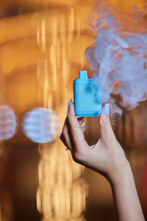 middle aged woman is exhaling vape smoke.の写真素材