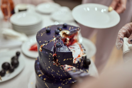 Black bunk cake on the dark black background with golden stars and spheres decoration on top....