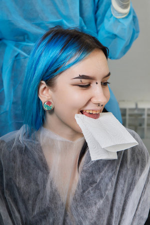 tongue splitting. cutting the tongue, one type of modification of the human body. surgery concept.の写真素材