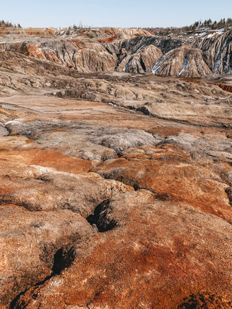 Clay Open Quarry Mars Landscape with Orange Water. Abandoned Rock Texture Old Porcelain Pit Mine in Ural. Erosion Crack Hill Desert Surface.の写真素材