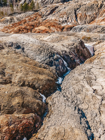 Clay Open Quarry Mars Landscape with Orange Water. Abandoned Rock Texture Old Porcelain Pit Mine in Ural. Erosion Crack Hill Desert Surface.の写真素材