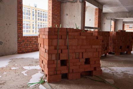 Construction worker laying bricks on exterior walls
