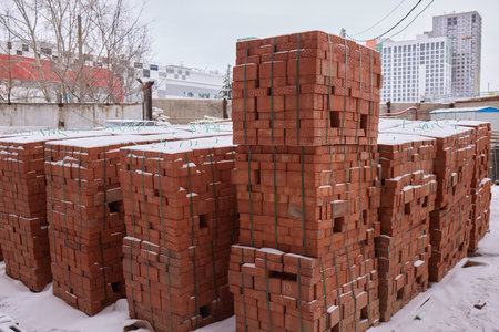 Construction worker laying bricks on exterior wallsの写真素材