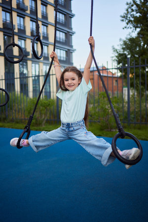 Little girl playing on the slider, Little pretty girl is having fun outdoor , happy preschool little kidの写真素材