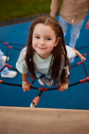 Little girl playing on the slider, Little pretty girl is having fun outdoor , happy preschool little kidの写真素材