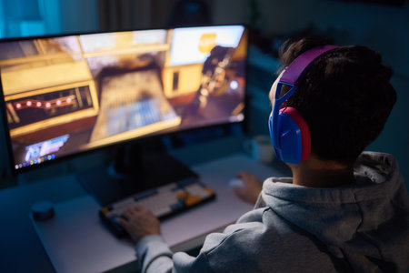 Player looking at his computer screen, contemplating his next move in an online video game.