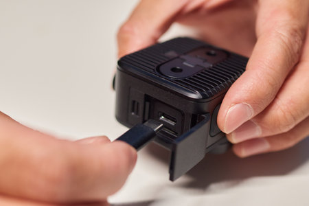 Man holding action camera in hand. It is a compact, lightweight personal camera