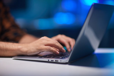 Young man using laptop in room at homeの写真素材