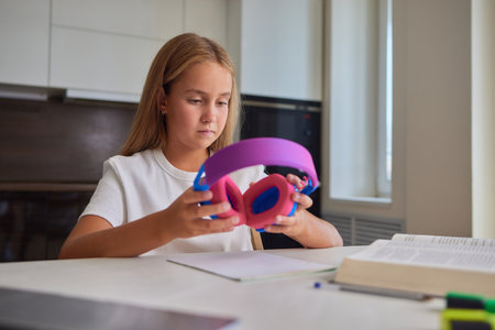 portrait of a young girl listening to music at home