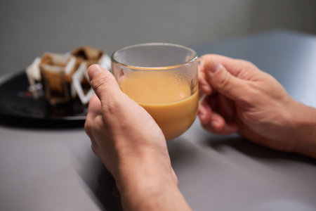 Cup of hot cappuccino coffee on tableの写真素材