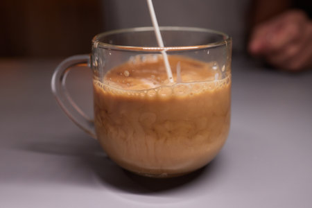 Cup of hot cappuccino coffee on tableの写真素材