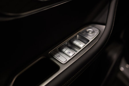 Buttons to lock and unlock the locks on the drivers door of a new modern premium car