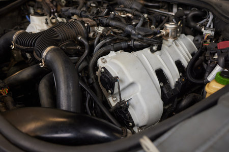 Mechanic using wrench while working on car engine at garage workshop, Car auto services and...