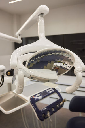 Modern dental practice. Dental chair and other accessories used by dentists in blue, medic lightの写真素材