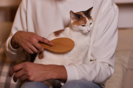 young man holding and petting cute cat maleの写真素材