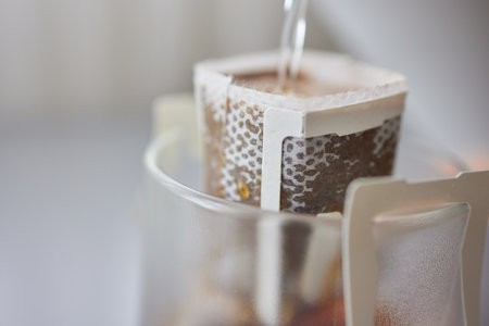 The process of brewing coffee. Water is poured into a drip coffee bag in a mug. Trends in brewing coffee at home.の写真素材