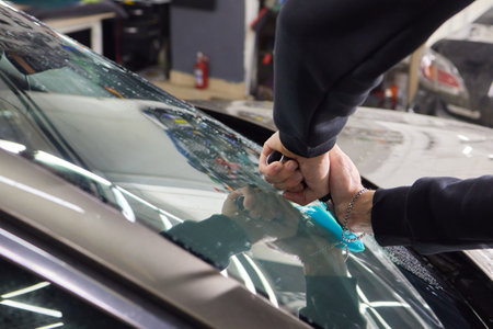 Windshield protection film installation series : Installing protection filmの写真素材