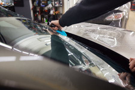 Windshield protection film installation series : Installing protection filmの写真素材