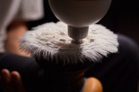 Car detailing - Man with orbital polisher in repair shop polishing car. Selective focusの写真素材