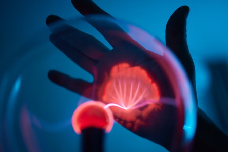 plasma ball. Hands holding plasma light ball. Plasma ball light ray science. Finger touching Plasma...