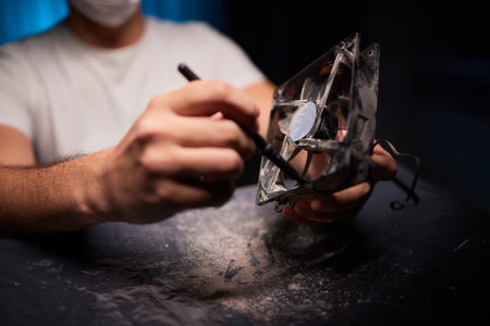 Cleaning a processor fan with a brushの写真素材