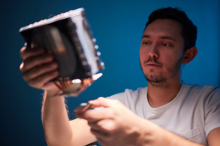 Cropped image of an engineer showing a computer microchip on the foreground