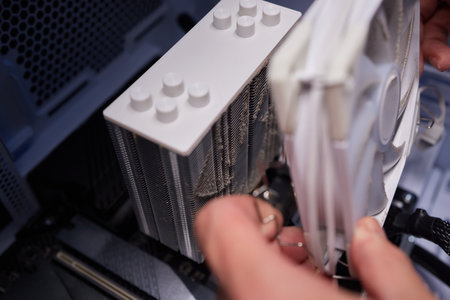 Cleaning a processor fan with a brushの写真素材