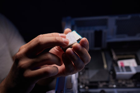 Cropped image of an engineer showing a computer microchip on the foregroundの写真素材