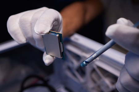 Cropped image of an engineer showing a computer microchip on the foreground