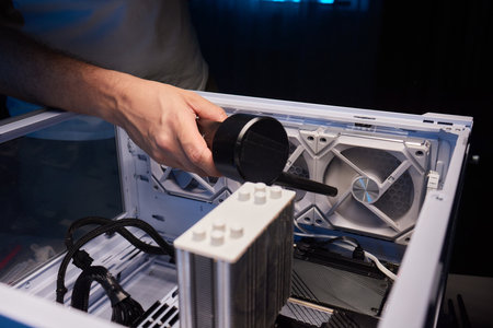 Cleaning the computer video card from dust with a brush and air. Computer fans in dust