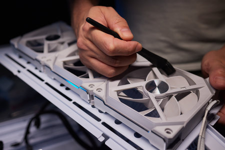 Cleaning a processor fan with a brushの写真素材