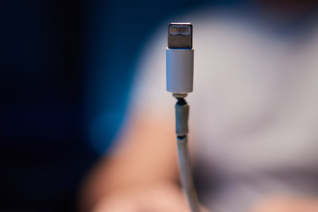 Old charger cable broken and smartphone, Defective charging cord, Connection deterioration device