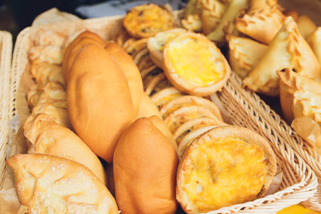 Assortment of sweet pastries on the cafe counter, bread roll with poppy seeds, cinnamon and raisins.の写真素材