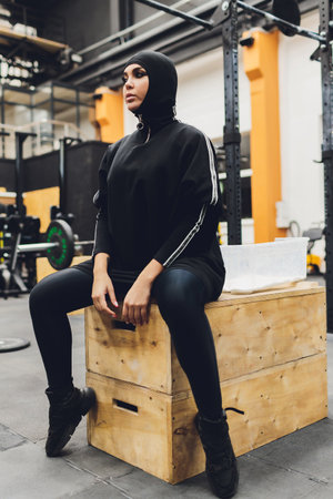 Muslim asian woman in hijab exercizing in a gym.の写真素材