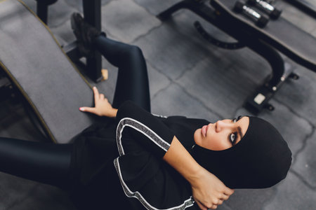 Muslim asian woman in hijab exercizing in a gym.の写真素材