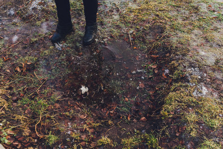 young woman washes legs in a puddle.の写真素材