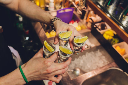 Hand holding a glass with vodka shot.の写真素材