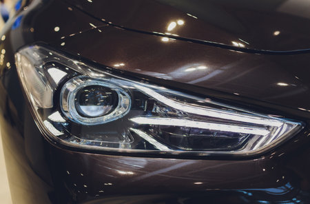colorful headlights of white car after the rain at night on car parking.の写真素材