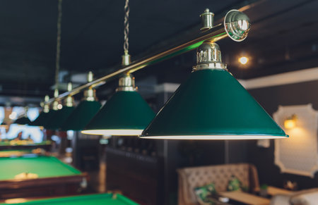 lamp over billiards green table balls and cues.の写真素材