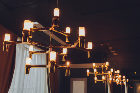 Different modern streamlined mirror copper chandeliers. Bubble metal copper shade pendant.の写真素材