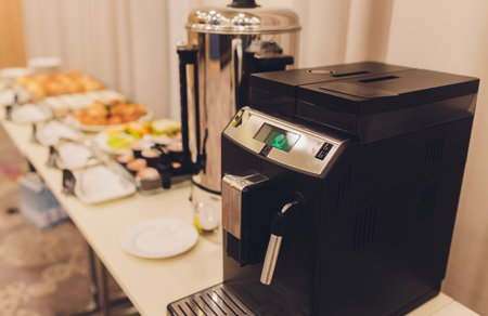 Frontal view of two coffee machines on a desk used for coffee break on an event or a meeting. Coffee time on a seminar - table with machines ready to serve coffee.の写真素材