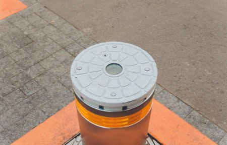 closeup of automatic car parking extending pillar, barrier at pedestrian only zone bridge, sidewalk. prevent vehicle driving, terrorist attack. crowd of people blurred on background. selective focus.の写真素材