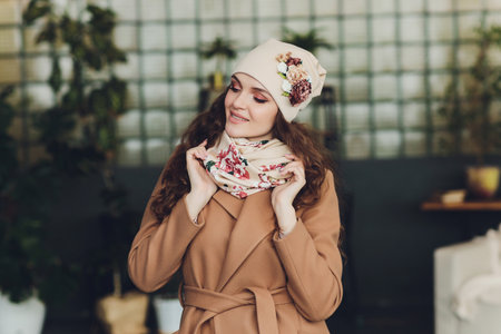 Surprised happy beautiful woman looking sideways in excitement. Christmas girl wearing knitted warm hat and mittens, isolated on gray background.の写真素材