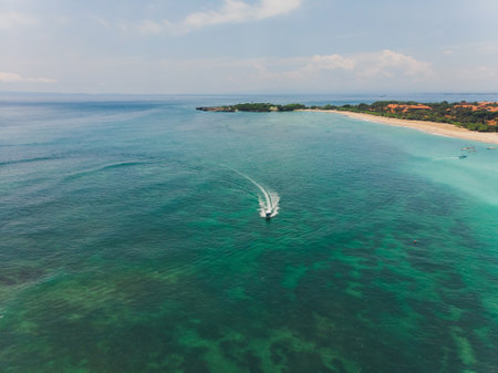 beautiful turquoise ocean water with boat on it top view aerial photo.の写真素材